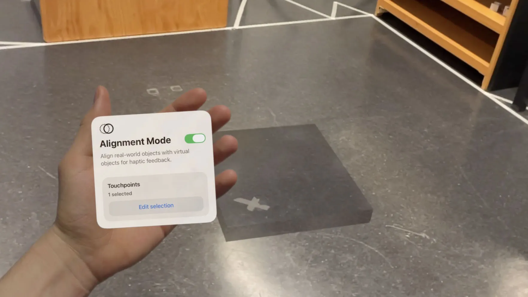 A semi-transparent virtual seat block on the floor of a real room, next to the palm menu with one touchpoint selected
